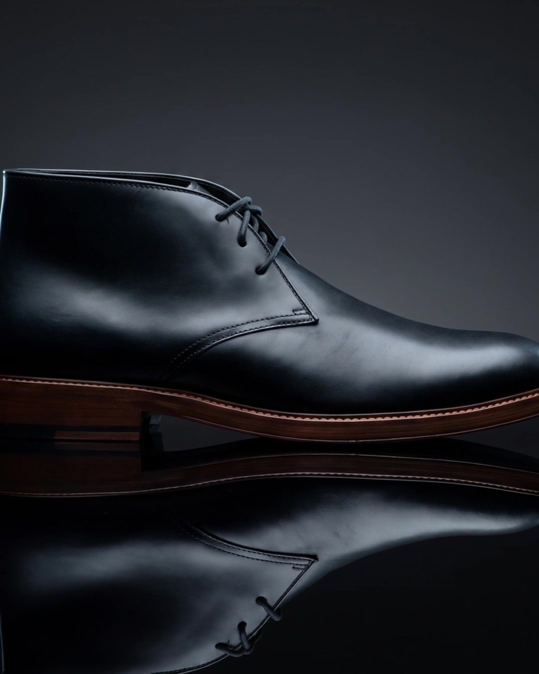 A Gordon Rush Austin chukka boot on a reflective surface
