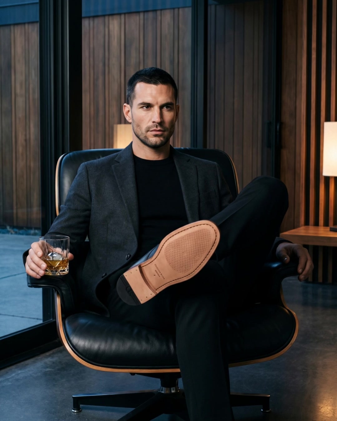 A seated man showing the leather sole of a Gordon Rush boot